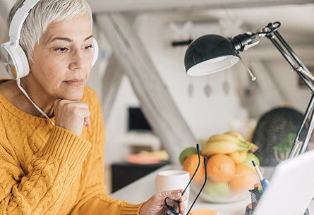 Women at desk with headphones