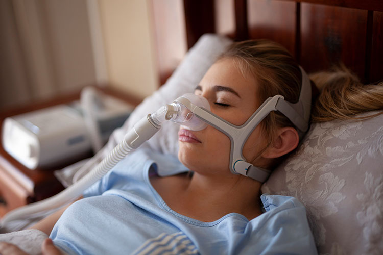 woman using resmed sleep apnea machine