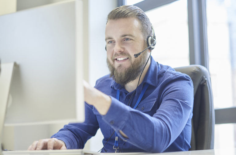 adult male working in customer support call center