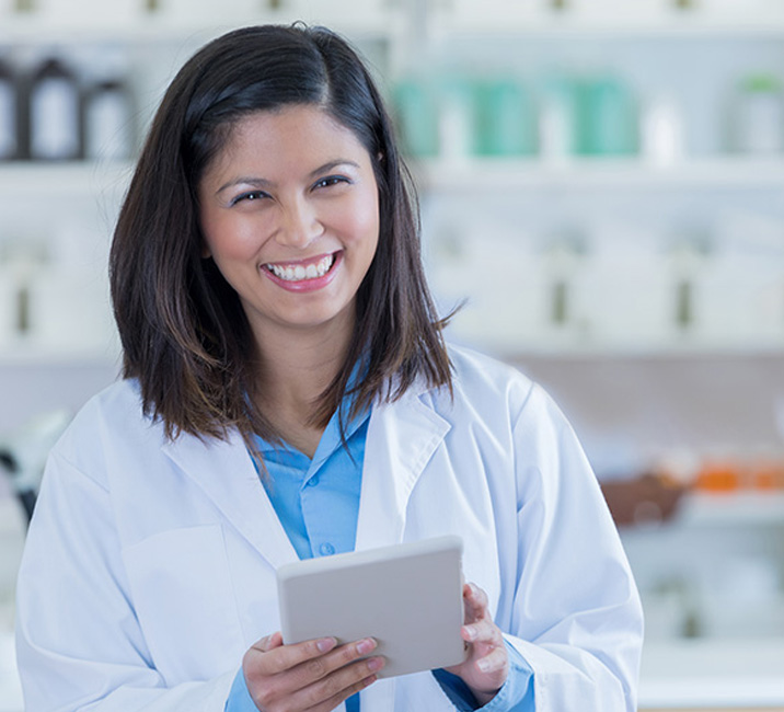 female pharmacist holding mobile device