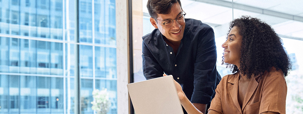 Couple in a discussion sitting in a high rise glassed wall office