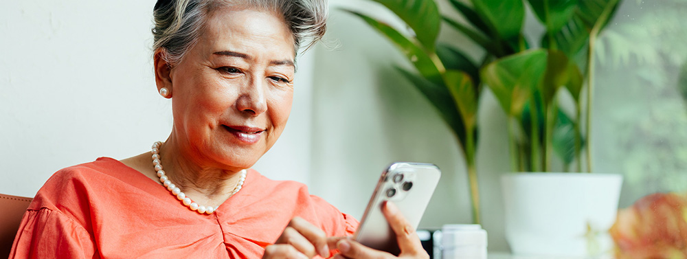 Older elegant lady looking at her mobile phone